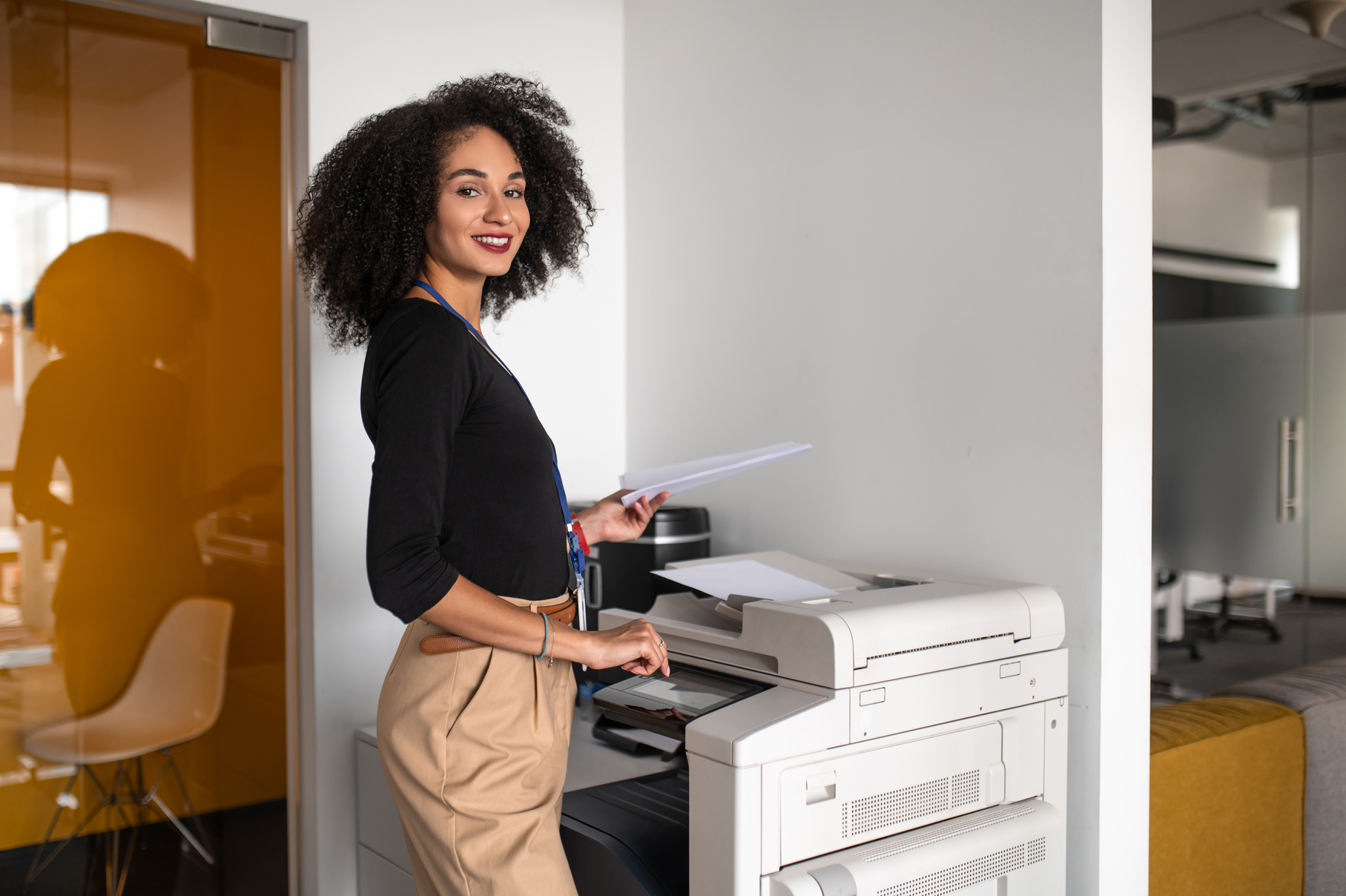 Woman standing near the xerox in the office